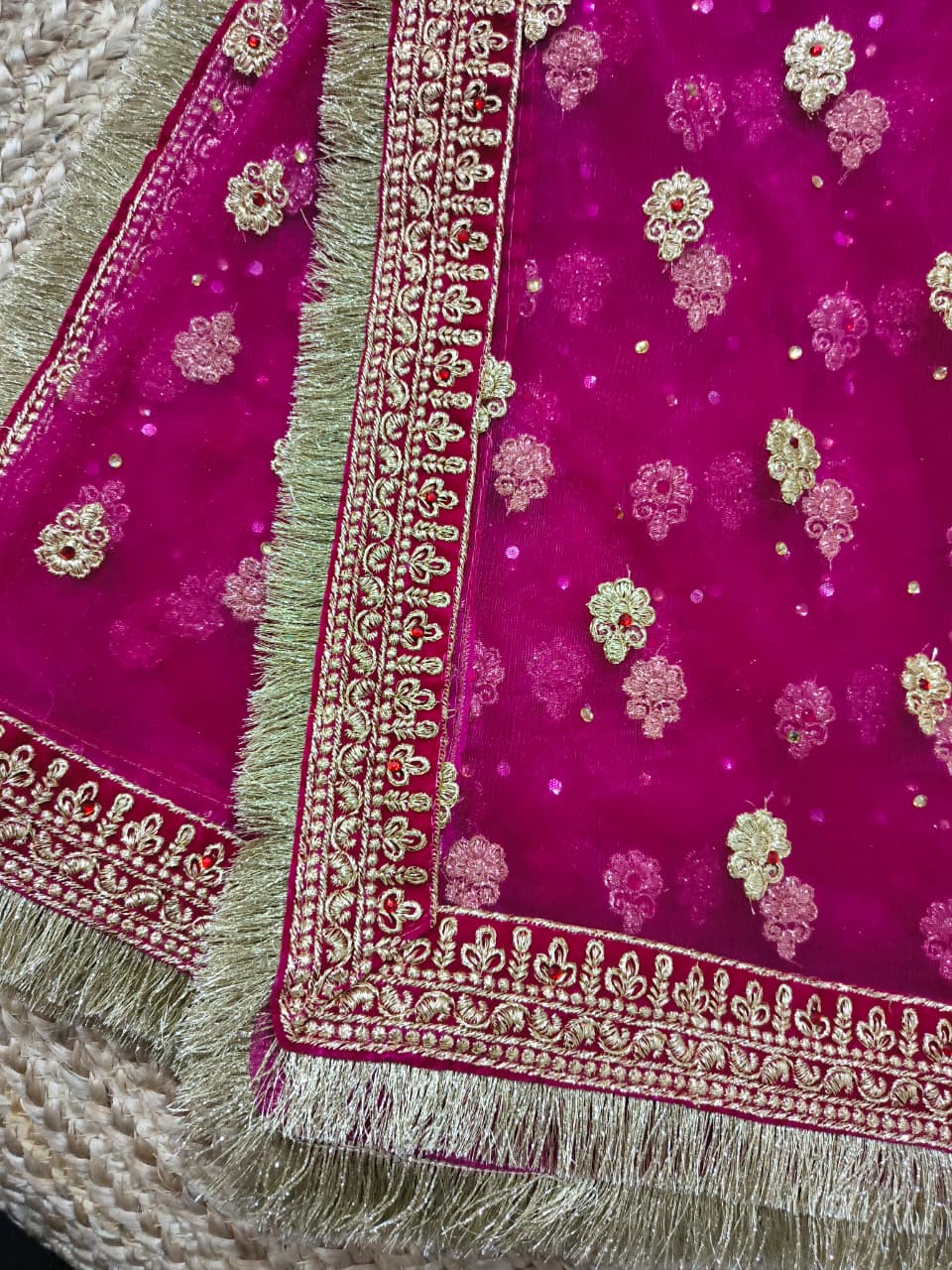 Magenta net dupatta flat lay showing allover gold booti embroidery and fringe, Veera Products